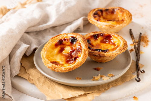 Wallpaper Mural Three Pastel de Nata, Portuguese custard tarts, are presented on a plate with cinnamon and vanilla beans. Torontodigital.ca