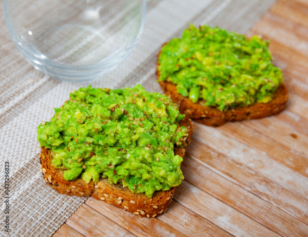 Appetizing toast with guacamole served on plate for breakfast Appetizing toast with guacamole served on plate for breakfast
