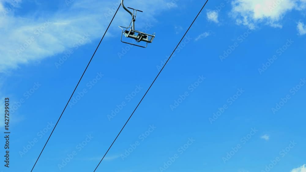 Cableway in the mountains.Summer season in the mountains.funicularin the blue sky in the mountains. Vehicle for climbing mountains. 4k footage Cableway in the mountains.Summer season in the mountains.funicularin the blue sky in the mountains. Vehicle for climbing mountains. 4k footage