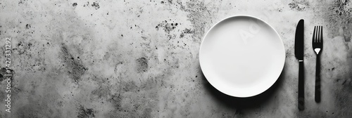 Empty plate with cutlery, and table.