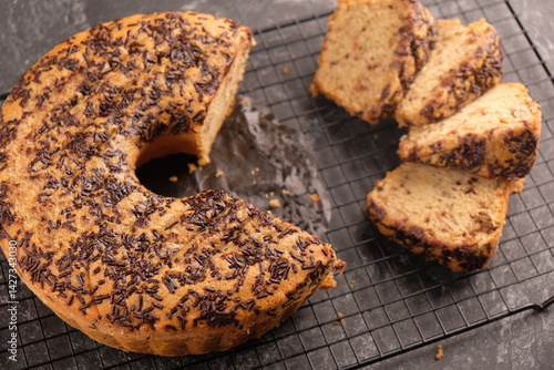 Canvastavla Slice banana cake sprinkled with chocolate on a cooling rack