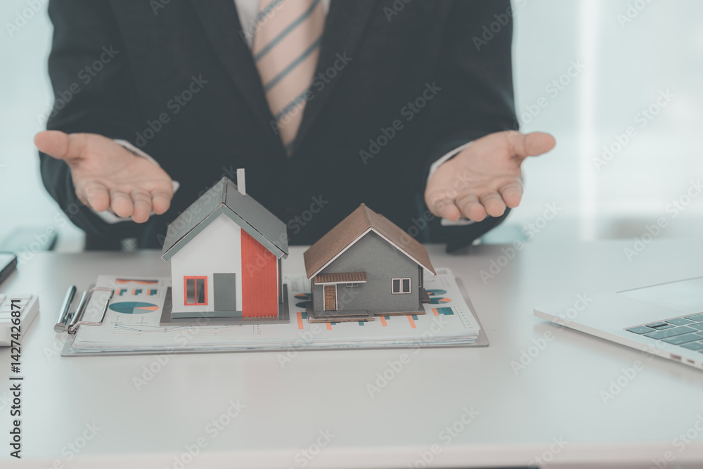 Real estate businessman presenting home loan and presenting house to customer after discussing and signing contract with approved application. Close up.