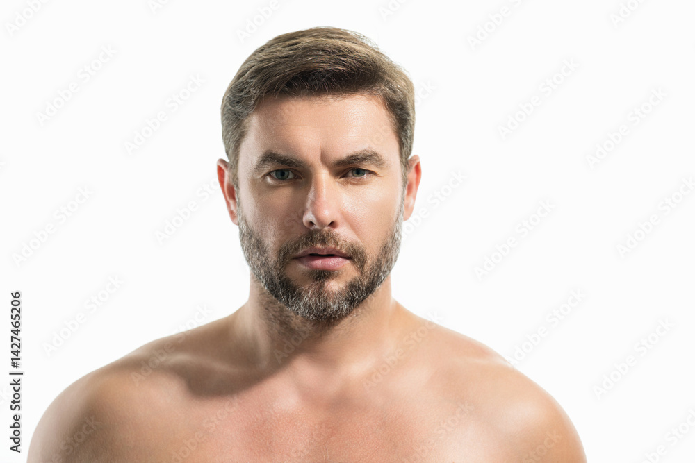 Obraz premium Close up beauty portrait of half naked satisfied young man after facial cream. Attractive brunet guy touching skin. Men model face with beard and modern haircut.