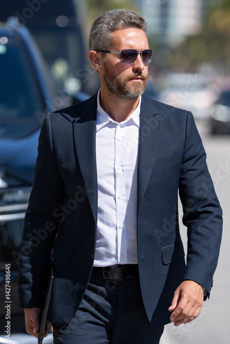 Obraz na płótnie Business man in suit outdoors. Rich businessman next to a luxury car. Global business. Successful business. Elegant business man in front of expensive car. Successful businessman. w salonie