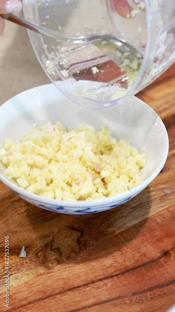 Chopping and Preparing Garlic in a Kitchen Chopping and Preparing Garlic in a Kitchen