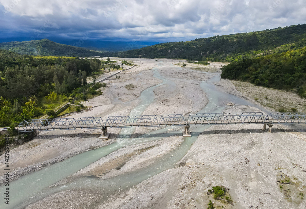 Aerial view of the construction of a bridge over a river crossing in Hatu Bulico Village, Ainaro Municipality, Timor Leste. The development of transportation access is still very much needed in Timor