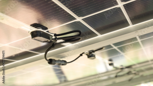 Solar junction box. Close-up of black diode blocks in a row under the solar panels in a smart farm with copy space and focus selection.