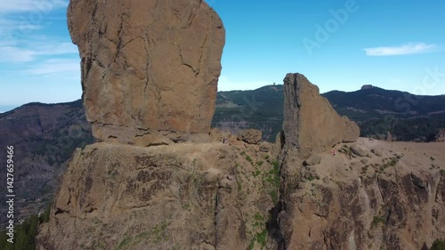 Aerial video of huge 90-metre tall volcanic rock 'Roque Nubile' perched above Gran Canaria, Spain