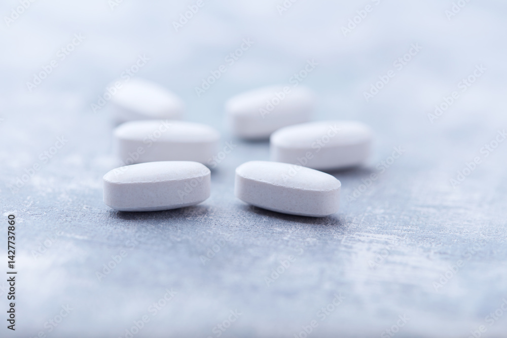 Amino acids tablets on wooden background. Soft focus. Close up Amino acids tablets on wooden background. Soft focus. Close up