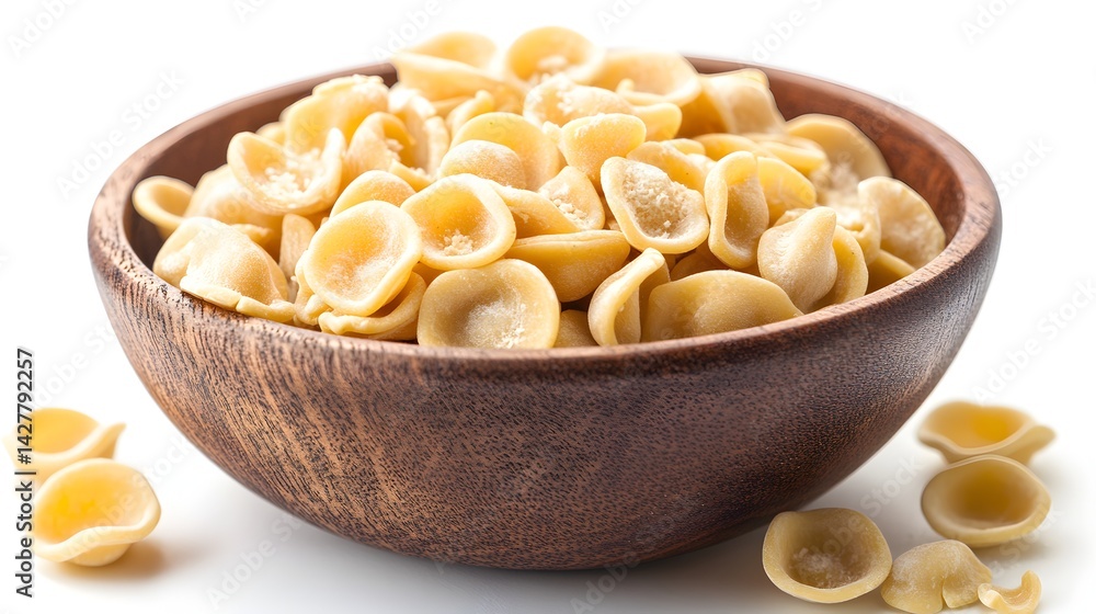 A wooden bowl overflows with delicious, uncooked orecchiette pasta ready for a flavorful Italian meal. A wooden bowl overflows with delicious, uncooked orecchiette pasta ready for a flavorful Italian meal.
