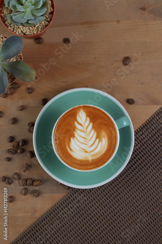 flat lay angle of a cappuccino with latte art in a tosca cup