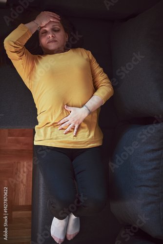 Obraz na płótnie Woman with strong stomach ache, menstrual and digestive issues at home. w salonie