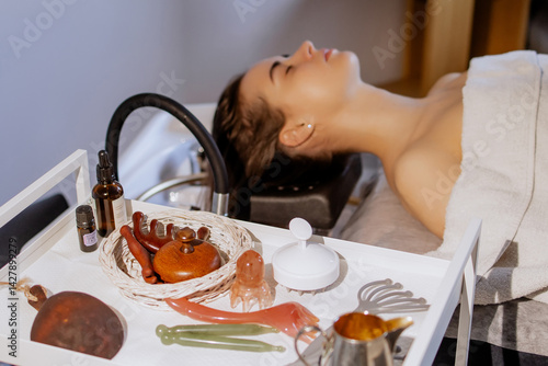 Japanese head spa treatment: Wooden tools, essential oils, and therapeutic equipment for a relaxing scalp massage and rejuvenating experience in a beauty salon