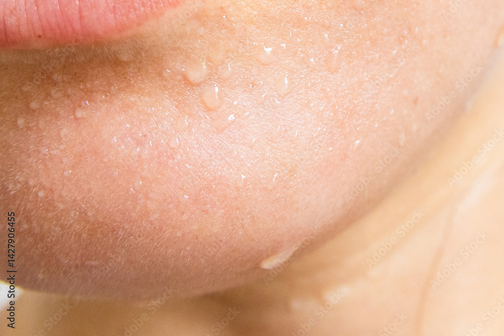 Fototapeta premium Close-up of a woman's face sweating in the hot summer