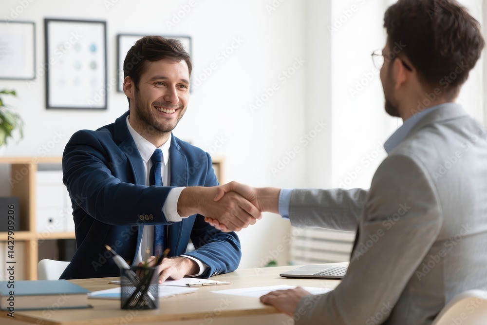 Portrait of cheerful young manager handshake with new employee. Portrait of cheerful young manager handshake with new employee.