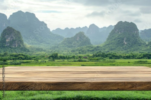 Wooden table top with a green valley and mountain landscape background, with sunlight for product display presentation mockup design in a sunny day nature concept
