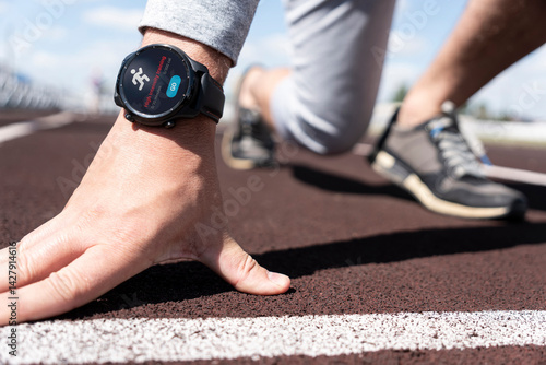 Obraz na płótnie Running man with smart watch. Concept of The technology to check health while exercising. high-intensity training with an app on smart watch w salonie