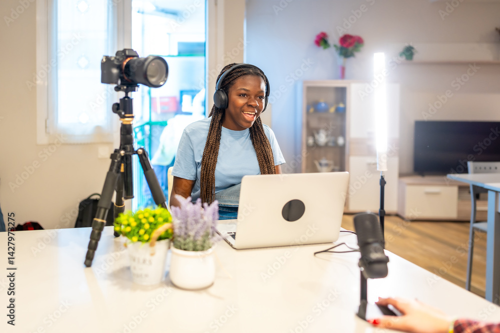 Young black female influencer recording a video blog at home