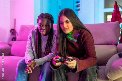 Concentrated friends playing video games at home