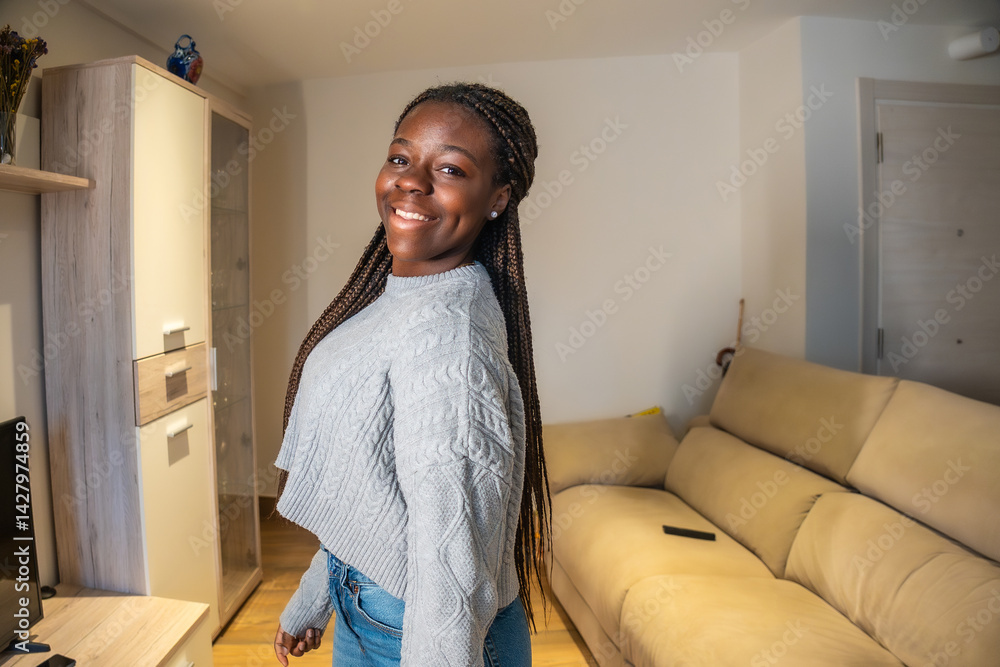 Smiling teenager posing at home in living room