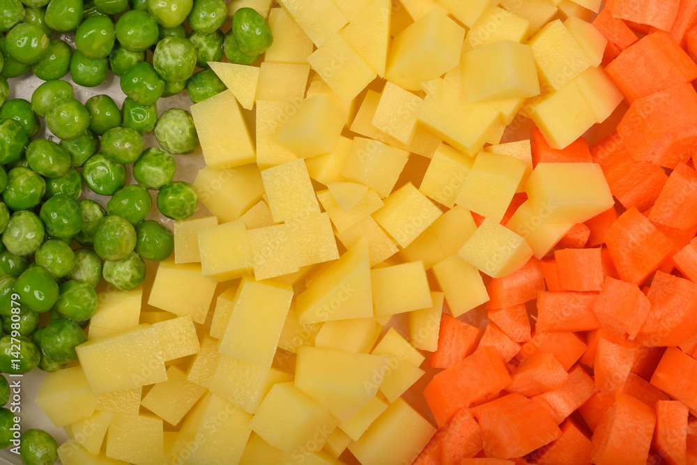 A top-down close-up shows neatly separated sections of green peas, diced potatoes, and diced carrots
