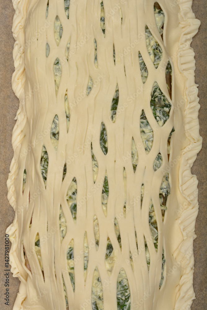 A close-up shows a lattice-topped savory pie filled with a creamy spinach mixture, ready for baking