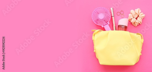 Obraz na płótnie Cosmetic bag with portable electric fan and female accessories on pink background with space for text w salonie
