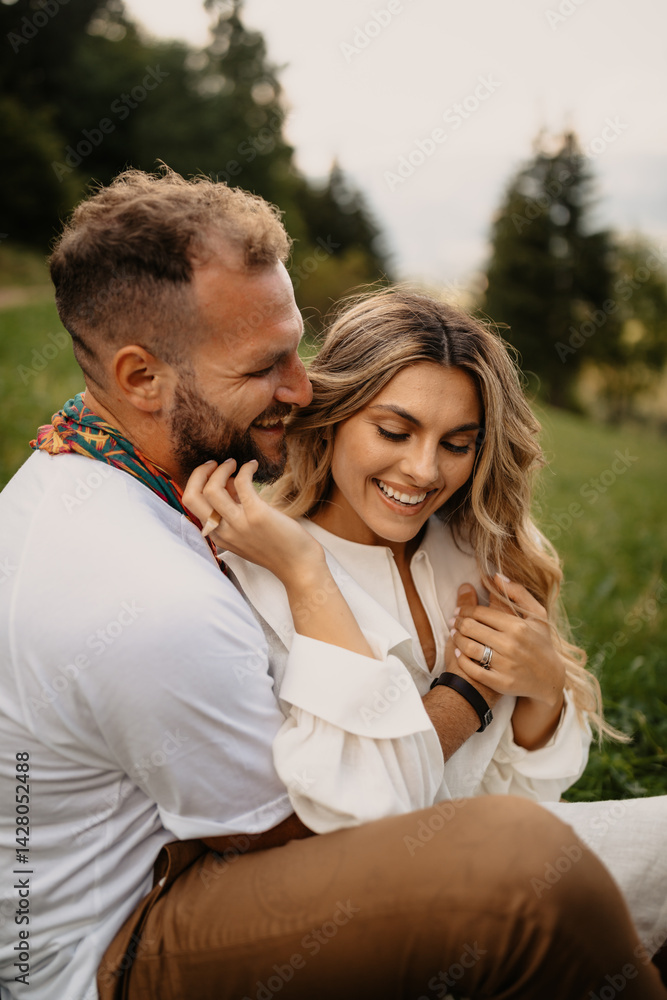 Happy couple embracing and smiling outdoors in nature Happy couple embracing and smiling outdoors in nature