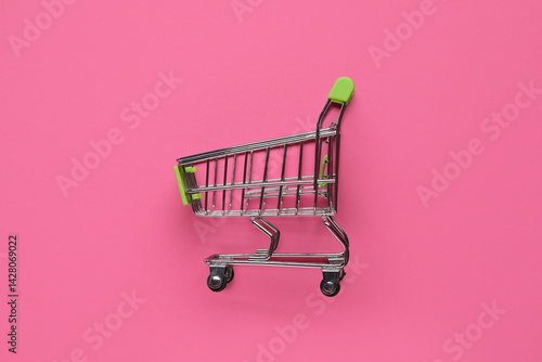 Shopping cart on pink backg...