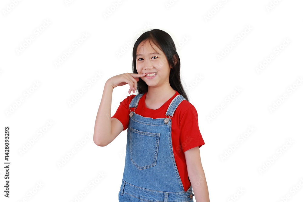 Portrait of Asian girl child keeping fingers on mouth and teeth isolated on white studio background. Kid standing and looking straight at camera.
