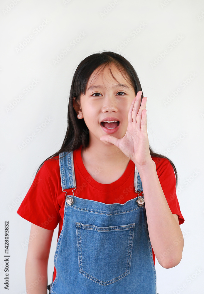 Portrait smiling Asian girl child standing with hand on mouth talking news announcement isolated on white studio background.