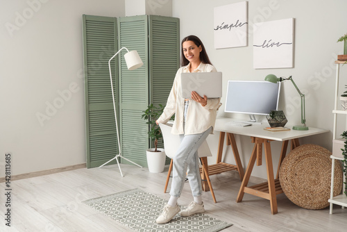 Young woman with laptop and...
