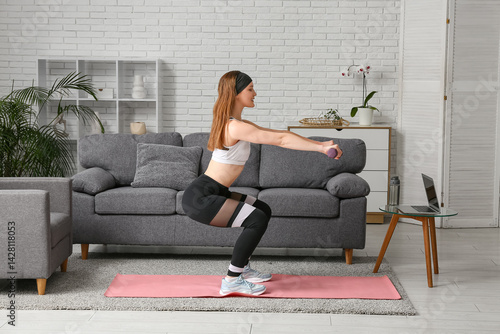 Young Woman Doing Squats wi...