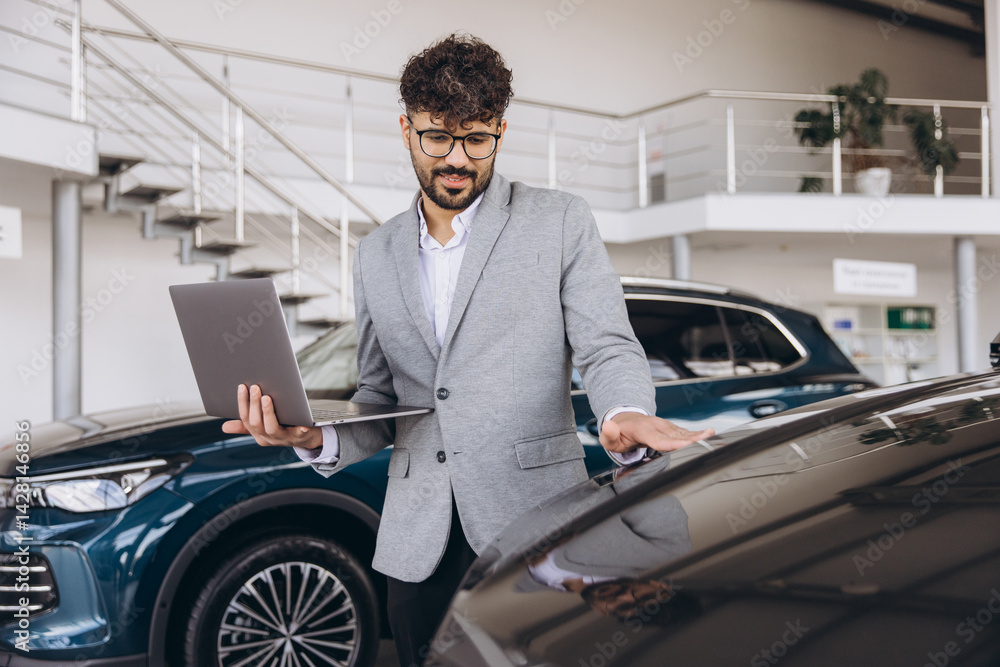 Car Salesman Showing a New Car to a Customer While Holding a Laptop Car Salesman Showing a New Car to a Customer While Holding a Laptop