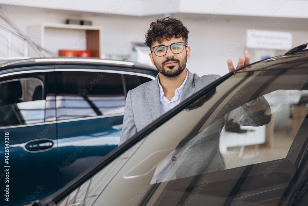 Salesman Showing New Car to Potential Customer in Dealership Salesman Showing New Car to Potential Customer in Dealership