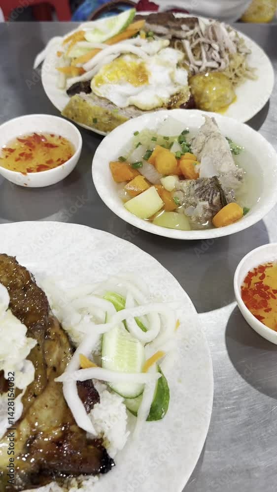 Vietnamese Home-Style Meal with Grilled Pork, Fried Egg, and Soup – Horizontal Pan Vietnamese Home-Style Meal with Grilled Pork, Fried Egg, and Soup – Horizontal Pan