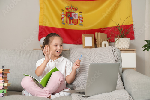 Remote learning and homeschooling, child using laptop for online education wi...
