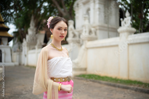 Obraz na płótnie Beautiful young Asean woman in traditional Thai Dvaravati dress in an old temple in Chiang Mai, Thailand. w salonie