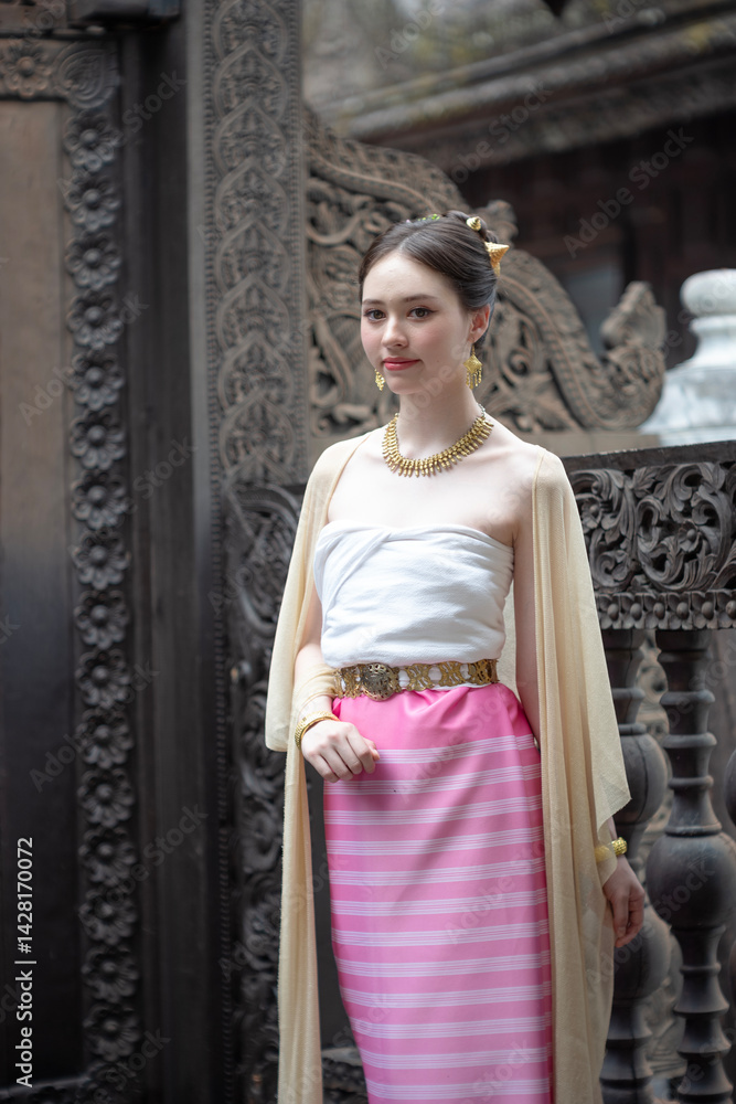 Beautiful young Asean woman in traditional Thai Dvaravati dress in an old temple in Chiang Mai, Thailand.