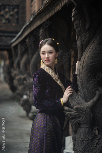 Obraz na płótnie Beautiful young Asean woman in traditional Thai Dvaravati dress in an old temple in Chiang Mai, Thailand. w salonie