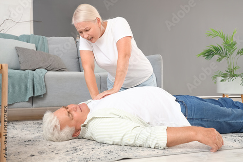 Mature woman doing CPR on h...
