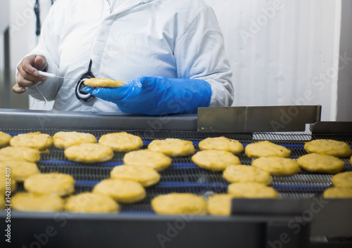 Breaded chicken production line in food factory  automated conveyor belt system in industrial food processing plant