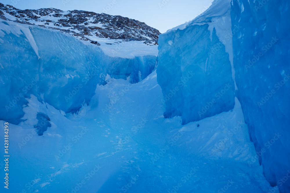 Majestic icy passage with deep blue frozen walls and mountains