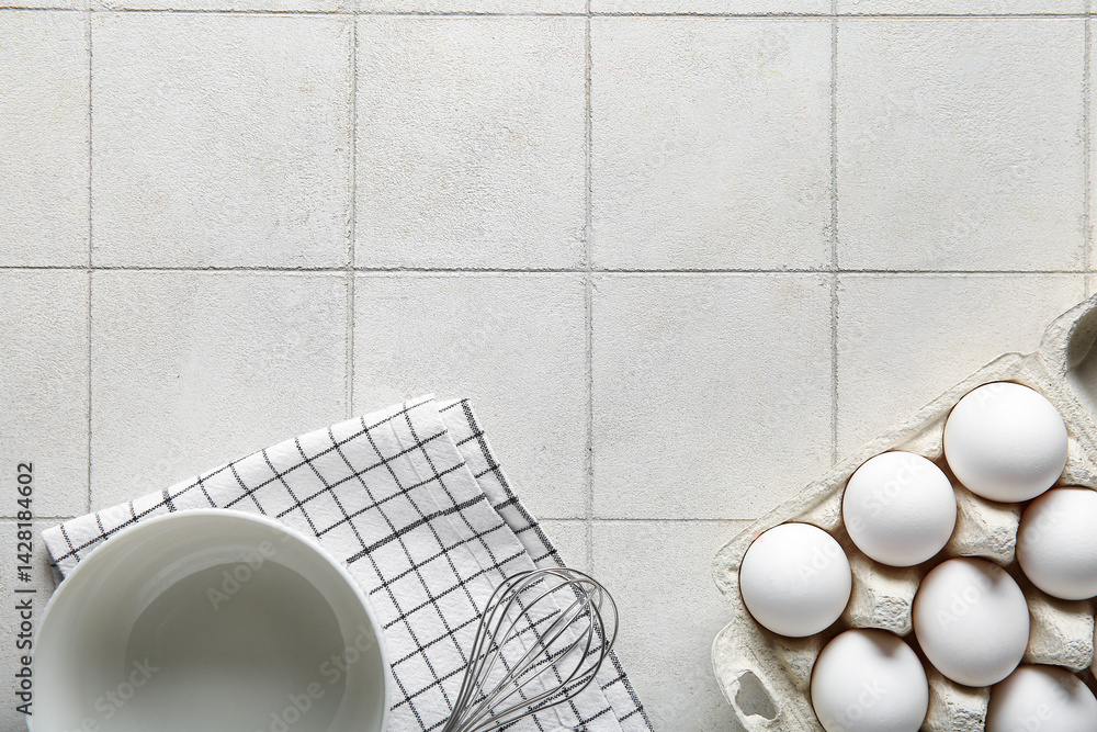 Holder with raw chicken eggs on white tile background