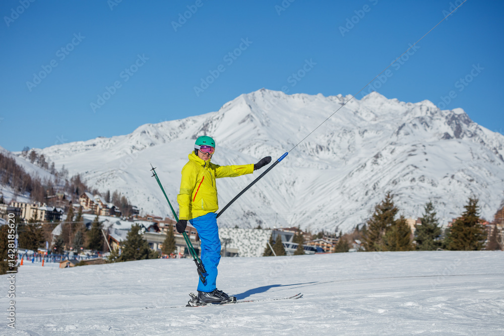 Happy skier man on the lift, ready for snowy adventures ahead