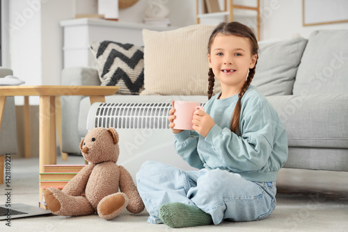Little girl with tea cup an...