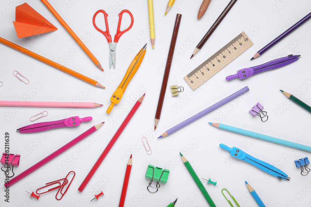 Composition with colorful pencils and school stationery on white background Composition with colorful pencils and school stationery on white background