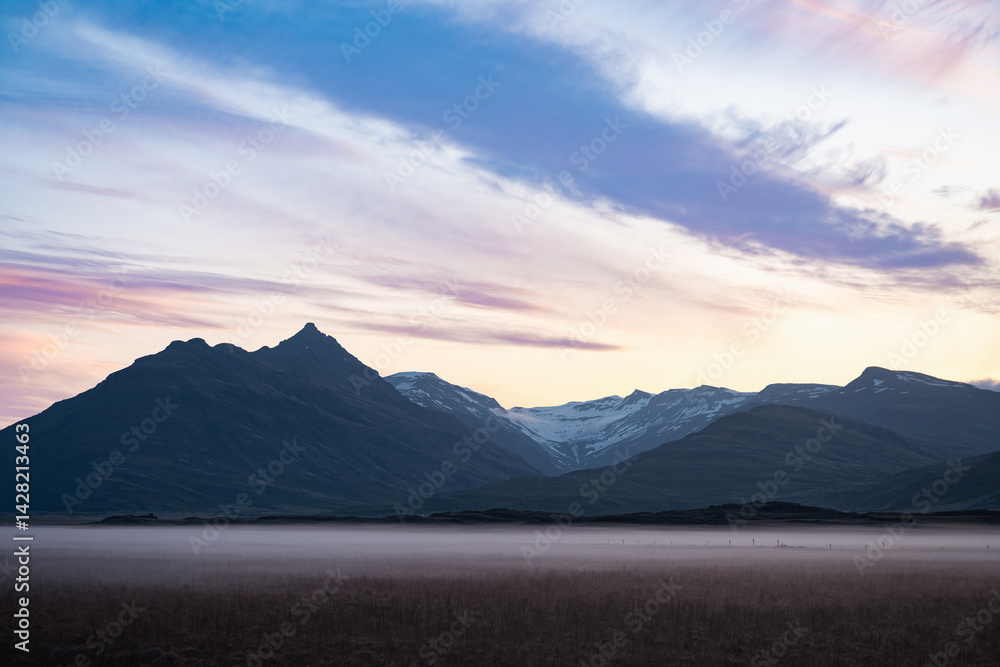 Twilight over Vatnajökull glacier in Iceland, with snow-covered peaks, pastel sky, rising crescent moon, and mist-covered plains evoking stillness and grandeur.