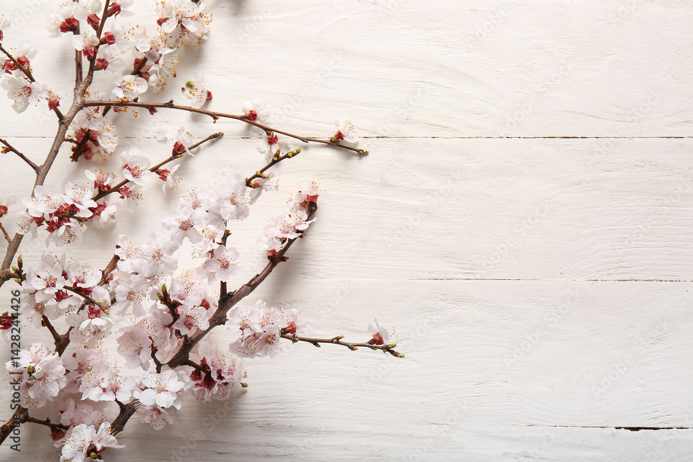 Beautiful blooming branches on white wooden background