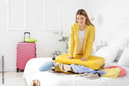 Young woman packing yellow ...